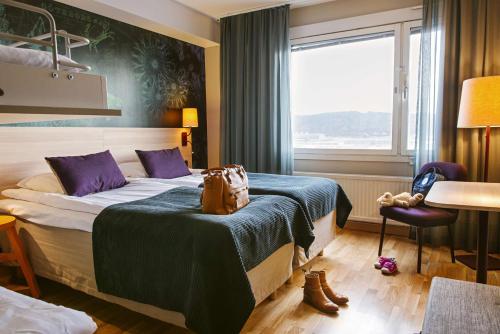 a hotel room with a bed and a window at Scandic Backadal in Gothenburg