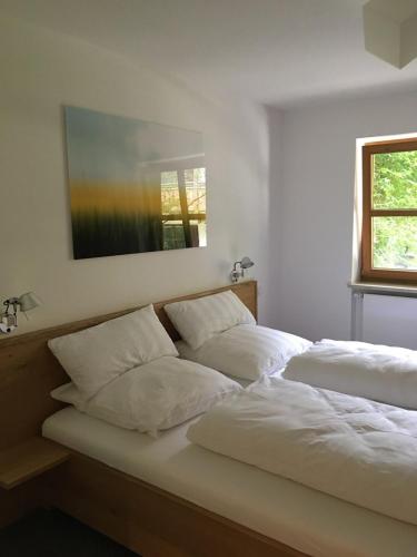 a bedroom with two beds with white pillows at Premium-Chalet Achental mit Kamin und Sauna in Schleching