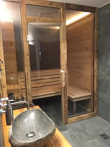 a bathroom with a sink and a sauna at Premium-Chalet Achental mit Kamin und Sauna in Schleching