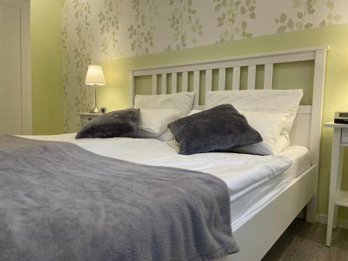 a bedroom with a bed with two pillows on it at Molehill Shire in Hückeswagen