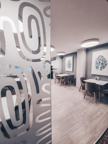 a conference room with tables and chairs and a screen at Pervaža in Panevėžys