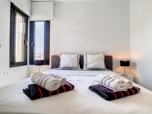 a bedroom with a bed with towels on it at Jardines de Montesolana Penthouse - 2110 in Los Dolses
