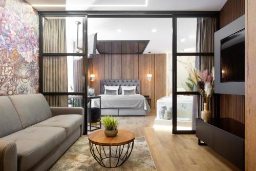a living room with a couch and a bed at Jacuzzi Apartment Main Square in Krakow