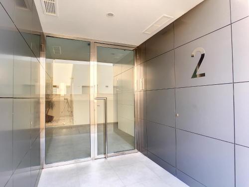 a glass elevator in a building with the number two at Jardines de Montesolana Penthouse - 2110 in Los Dolses