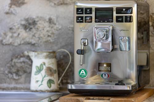 a toaster sitting on a counter next to a vase at Les Chambres du Lavoir Vert in Tourbes