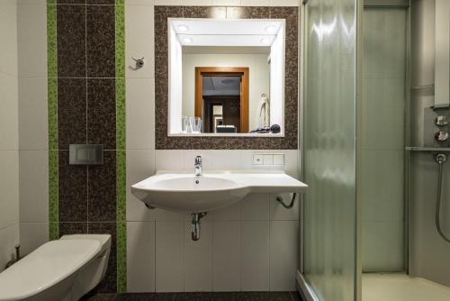 a bathroom with a sink and a mirror at 3 MostA in Saint Petersburg