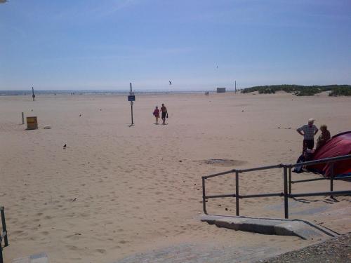 a group of people walking on the beach at Tal Y Don Hotel in Barmouth