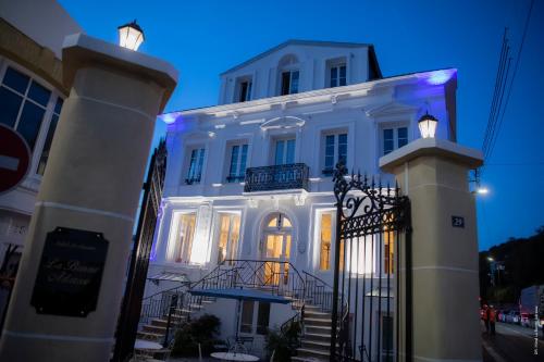 a white building with a gate in front of it at Hotel de Charme La Bonne Adresse - Logis hotels in Le Havre