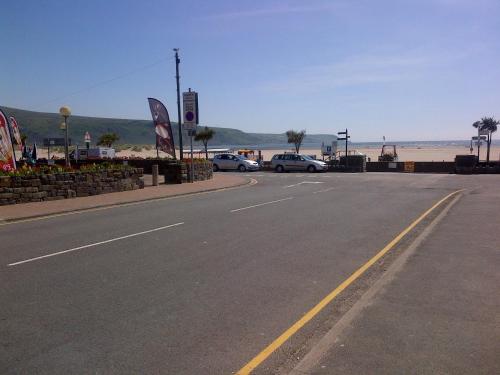 a street with cars parked on the side of a road at Tal Y Don Hotel in Barmouth