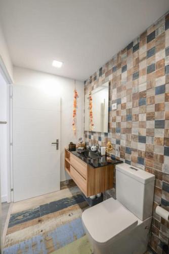 a bathroom with a toilet and a sink at Monchique Islet View House T1 in Faja Grande