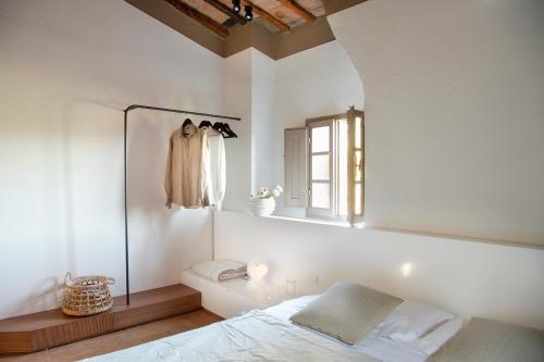 a bedroom with a bed and a window and a mirror at Salvadonica in San Casciano in Val di Pesa
