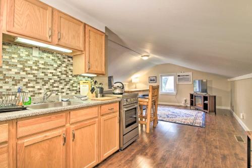 a kitchen with wooden cabinets and a counter top at Idyllic Wallingford Retreat - Near Skiing and Hiking in Wallingford