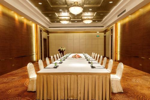 a long table in a room with chairs and a long table at Radisson Collection Hotel, Xing Guo Shanghai in Shanghai