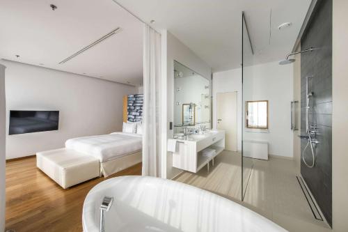 a hotel room with a bath tub and a bed at Radisson Blu Resort & Spa in Split