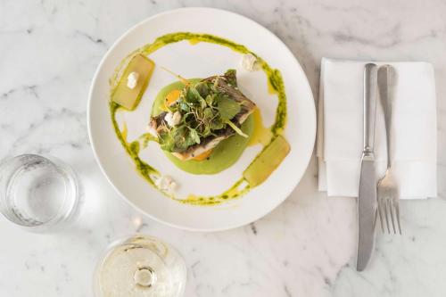 a plate with a dish of food on a table at Sails Port Macquarie by Rydges in Port Macquarie