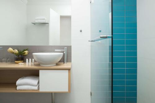 a bathroom with a sink and a shower at Sails Port Macquarie by Rydges in Port Macquarie