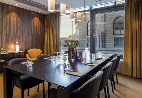 a dining room with a table and chairs at Radisson Collection, Strand Hotel, Stockholm in Stockholm