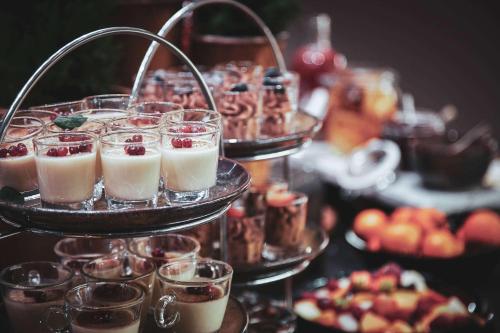 a display of desserts and other food on a table at Radisson Collection, Strand Hotel, Stockholm in Stockholm