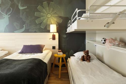 a bedroom with two beds and a teddy bear sitting on them at Scandic Helsingborg Nord in Helsingborg