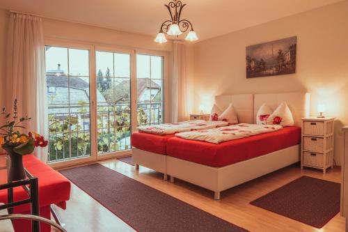 a bedroom with a bed and a large window at Coraline -Koblach in Koblach