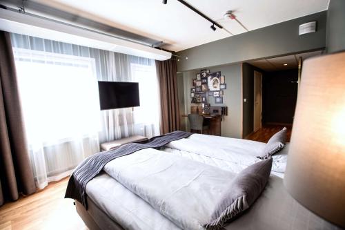 מיטה או מיטות בחדר ב-Scandic Uplandia