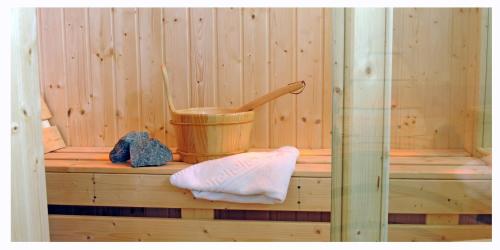 a sauna with a bucket and a thermometer in it at Atheras in Évdhilos