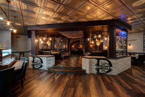 a restaurant with a bar with a fireplace at Ramada by Wyndham Vineland Millville Area in Vineland