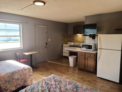 uma pequena cozinha com um frigorífico branco e um lavatório em Etown Motel em Elizabethtown