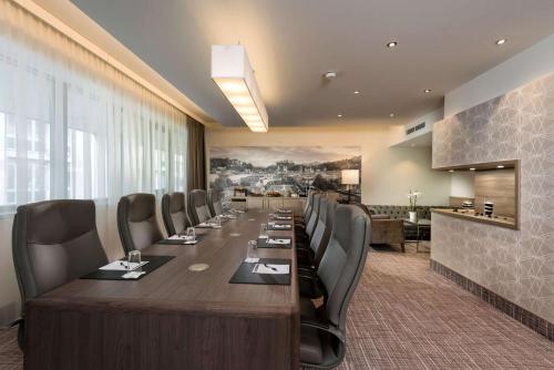 a large conference room with a long table and chairs at Wyndham Grand Salzburg Conference Centre in Salzburg