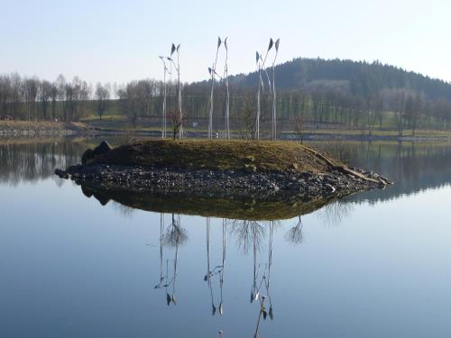 a small island in the water with grass on it at Hotel Munzert in Hof