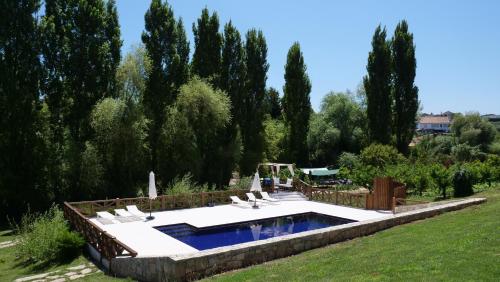 a swimming pool in a garden with lounge chairs at Casa Rosa, Quinta Carmo - Alcobaça/Nazaré in Alcobaça