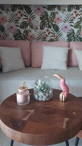 a coffee table with a pink bird on top of a table at Loutraki Pinky Pearl in Loutraki