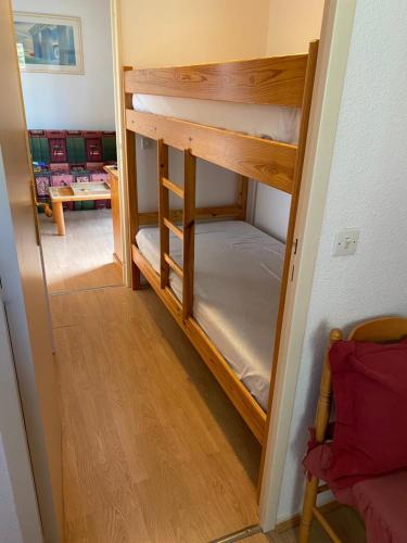 a hallway with a bunk bed in a room at Les Myrtilles Pyrénées 2000 in Bolquere Pyrenees 2000