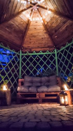 a room with a couch in the middle of a roof at Willa Ramzówka - Dom z Bilardem, Sauną i Jacuzzi in Nowy Sącz