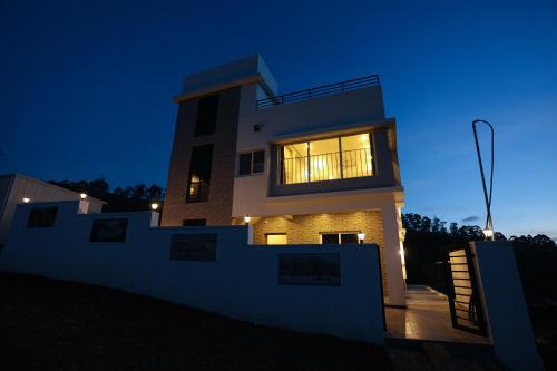 a house at night with the lights on at RR Holidays in Kodaikānāl