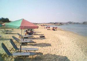 a group of chairs and umbrellas on a beach at Windmill Naxos in Naxos Chora