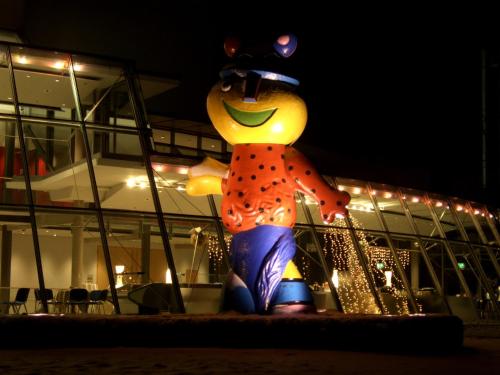 
a teddy bear is standing in front of a building at Hotel & Restaurant Munzert in Hof
