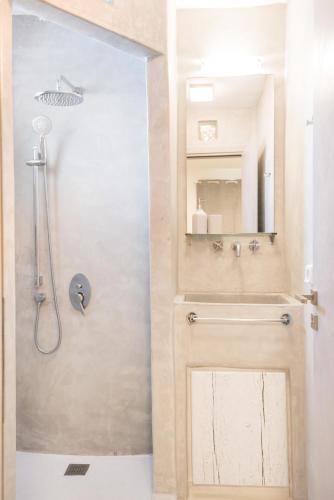 a bathroom with a shower and a sink at Andria's suites in Chrissi Akti