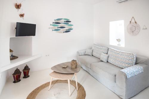 a living room with a couch and a table at Andria's suites in Chrissi Akti