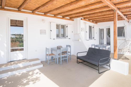a patio with a table and chairs and a table and chairs at Andria's suites in Chrissi Akti