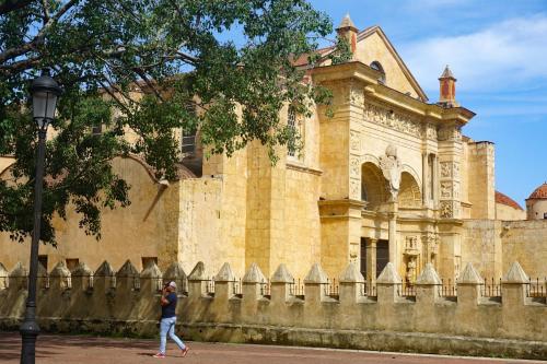 a person walking in front of a building at Hotel Señorial in Santo Domingo