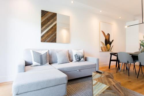 a living room with a couch and a table at Little Italy Spacious 2 Bedroom Condo Free Parking in Montréal