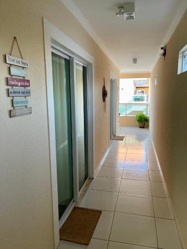 a hallway of a building with a tile floor at Bella Spiaggia Suítes in Flecheiras