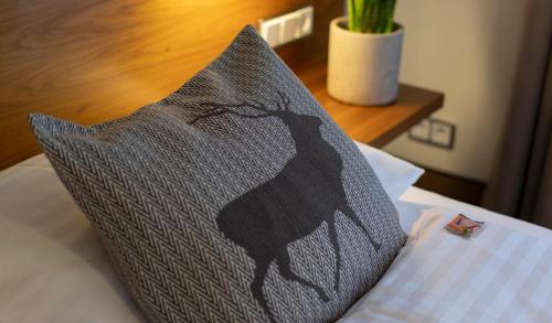 a pillow sitting on top of a bed at Hotel Residenz Hochalm - Joker Card Partner in Saalbach Hinterglemm
