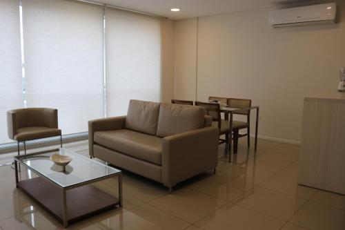 a living room with a couch and chairs and a table at START Villa Morra Rent Apartments in Asuncion