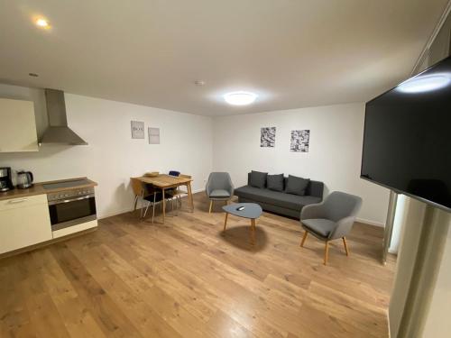 a living room with a couch and a table at City Apartments in Erfurt