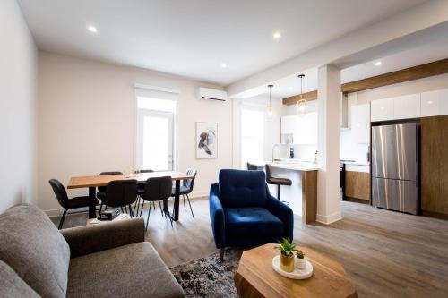 a living room with a couch and a table at Huge 2 Bdr with Balcony in Mile End by Den Stays in Montréal