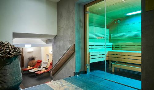 a room with a glass door and a stairway with a room with at Hotel Residenz Hochalm - Joker Card Partner in Saalbach Hinterglemm