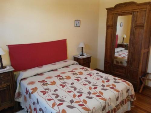 a bedroom with a large bed with a red head board at Hostería Restaurante del Puerto in Colón