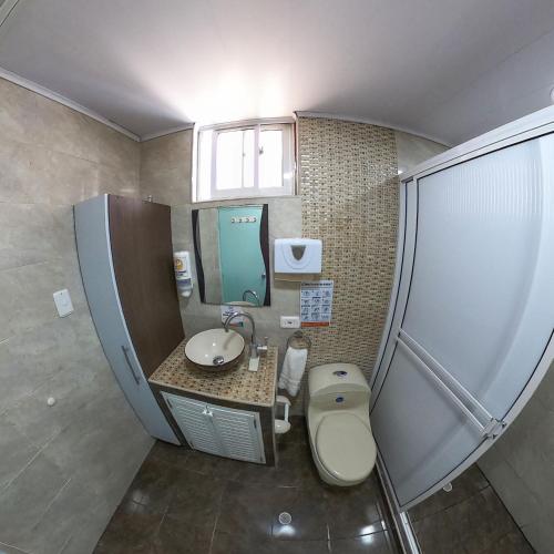a small bathroom with a toilet and a sink at Apartamentos Aury in San Andrés